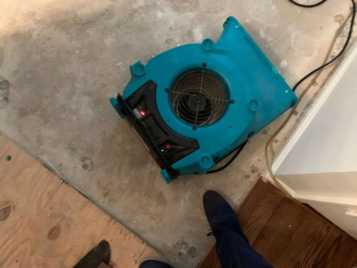 Air mover drying subfloor during Commercial Water Damage Restoration in Buford
